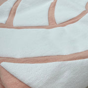 Close-up of a white volleyball graphic on a peach volleyball t-shirt