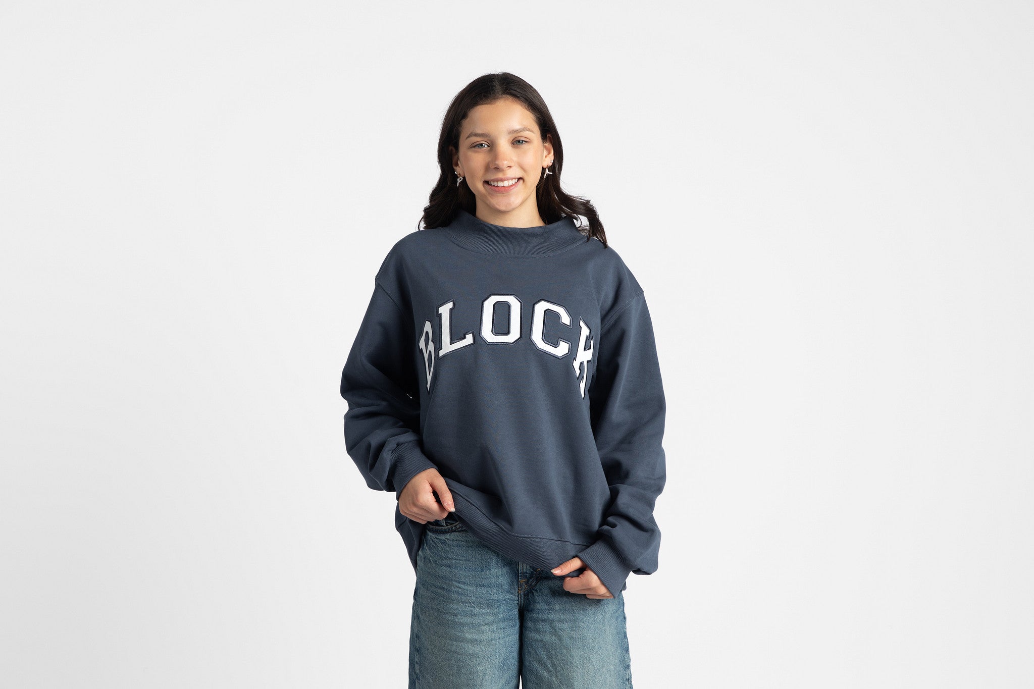Person wearing a navy blue volleyball sweatshirt with 'BLOCK' design