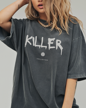 Girl wearing a gray volleyball t-shirt with 'KILLER' printed on it with volleyball graphic